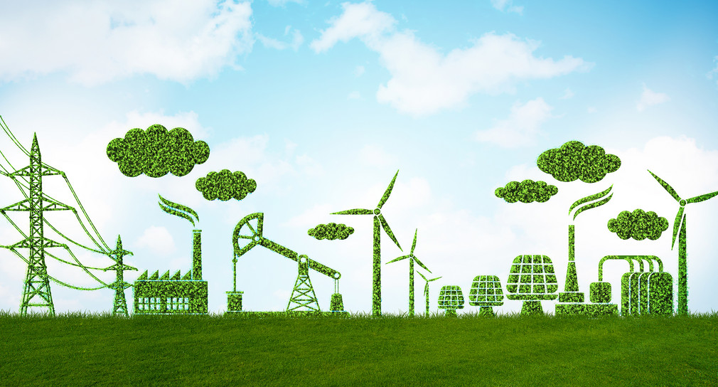 Symbolbild für Nachhaltige Wirtschaft - grüne Windräder, grüne Industriegebäude 