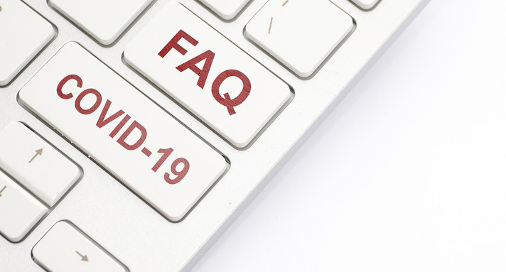 Tastatur mit der Aufschrift FAQ und Covid 19