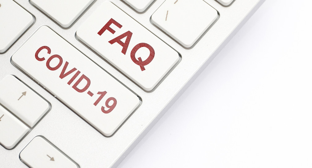 Tastatur mit der Aufschrift FAQ und Covid 19