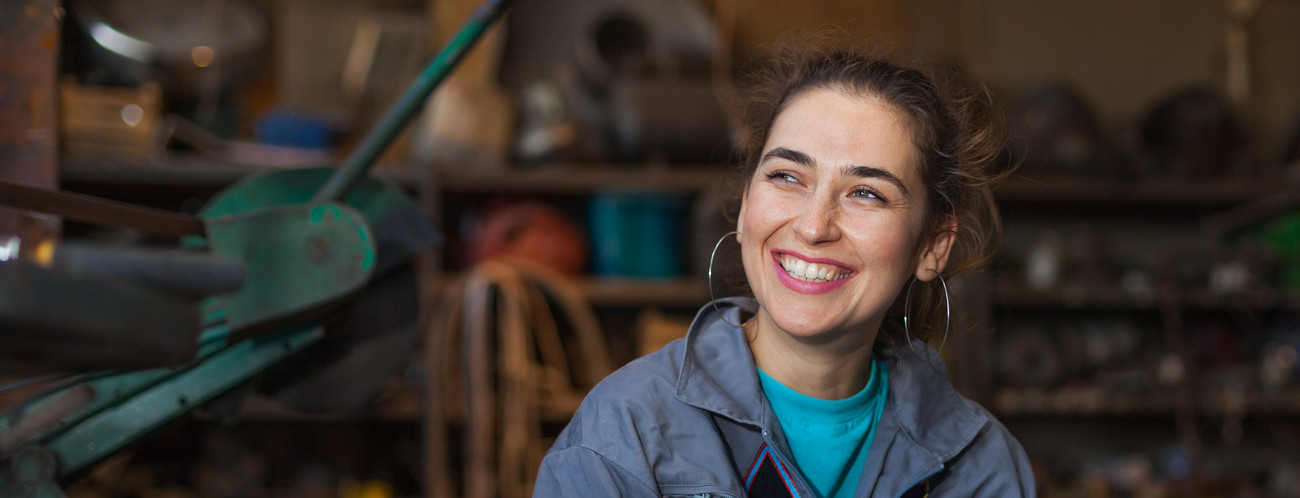 woman, young, mechanic, workshop, sitting, smile, worker, tomboy, happy, overalls, blue, indoors, background, dirt, dirty, face, tools, posing, satisfied, tough, thinking, female, repair, shop, adult, caucasian, industry, service, garage, work, technician, occupation, looking, girl, person, machinery, professional, equipment, apprentice, trainee, profession, workplace, smiling, blurred, brunette, beautiful