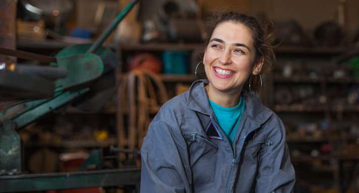 woman, young, mechanic, workshop, sitting, smile, worker, tomboy, happy, overalls, blue, indoors, background, dirt, dirty, face, tools, posing, satisfied, tough, thinking, female, repair, shop, adult, caucasian, industry, service, garage, work, technician, occupation, looking, girl, person, machinery, professional, equipment, apprentice, trainee, profession, workplace, smiling, blurred, brunette, beautiful